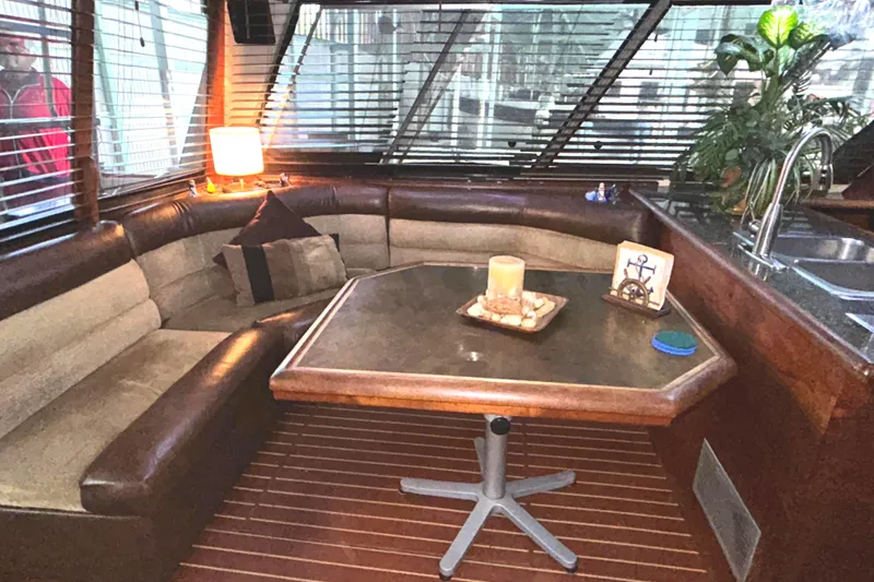 Slide: The Image of 1989 Bayliner 4588 Pilothouse interior with cozy seating and nautical decor. - 15