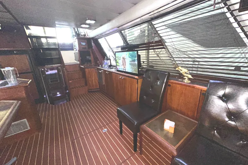 Slide: The Image of Interior of 1989 Bayliner 4588 Pilothouse with wood paneling and leather chairs. - 20