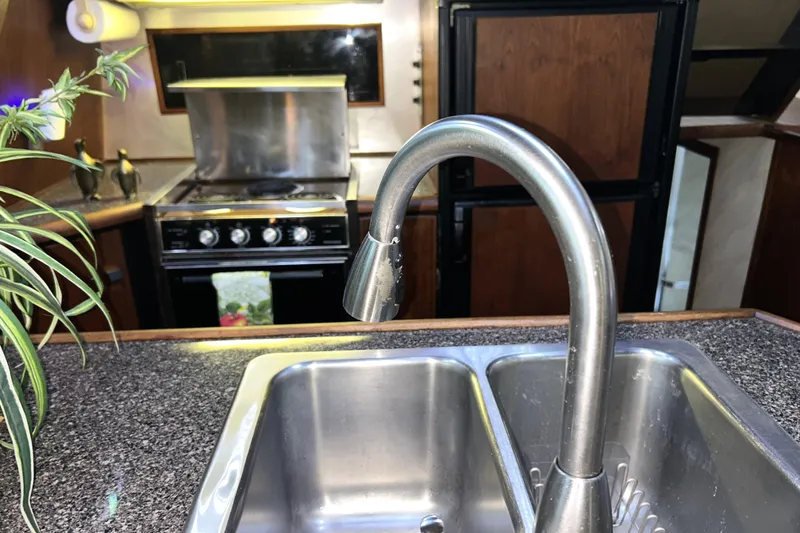 Slide: The Image of 1989 Bayliner 4588 Pilothouse galley with stainless steel sink and modern faucet. - 34