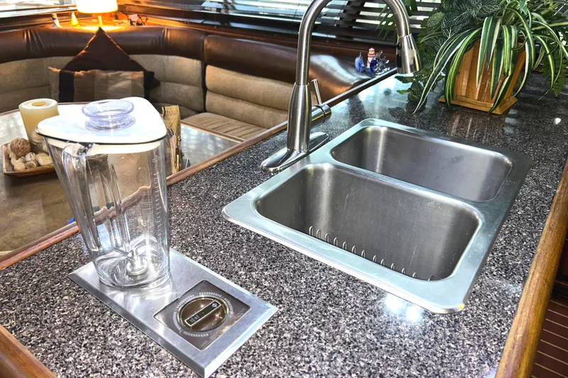 Slide: The Image of Luxurious 1989 Bayliner 4588 Pilothouse galley with dual sink and blender on custom countertop. - 36