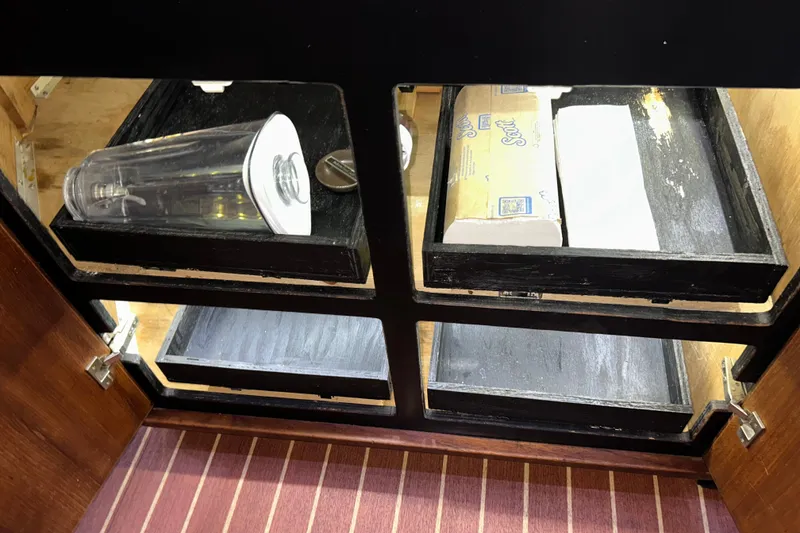 Slide: The Image of Open cabinet in 1989 Bayliner 4588 Pilothouse with storage shelves and items. - 38