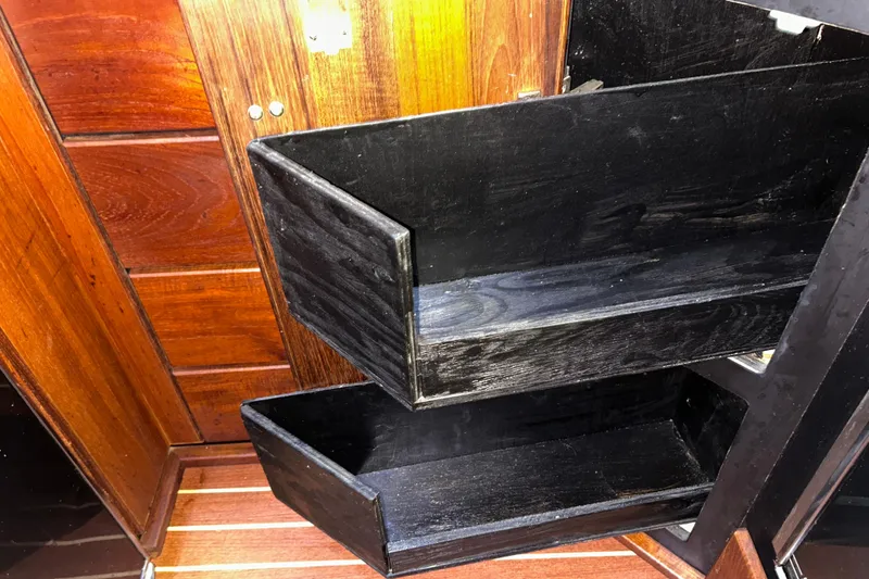 Slide: The Image of Wooden storage shelves inside a 1989 Bayliner 4588 Pilothouse boat interior. - 39