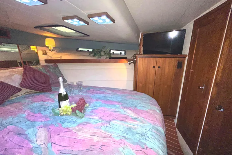 Slide: The Image of Luxurious 1989 Bayliner 4588 Pilothouse cabin with cozy bed and elegant decor. - 42
