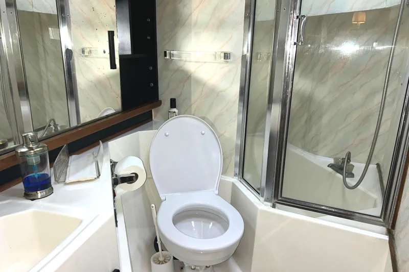 Slide: The Image of Bathroom interior of 1989 Bayliner 4588 Pilothouse yacht with tub/shower and standard toilet. - 51