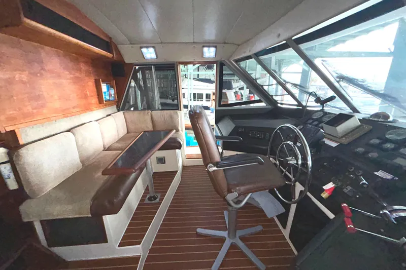 Slide: The Image of 1989 Bayliner 4588 Pilothouse interior with helm, seating, and wooden accents. - 59