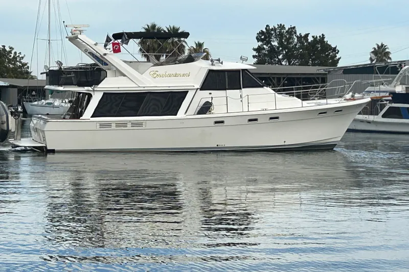 Slide: The Image of 1989 Bayliner 4588 Pilothouse yacht docked in a marina, side view. - 6