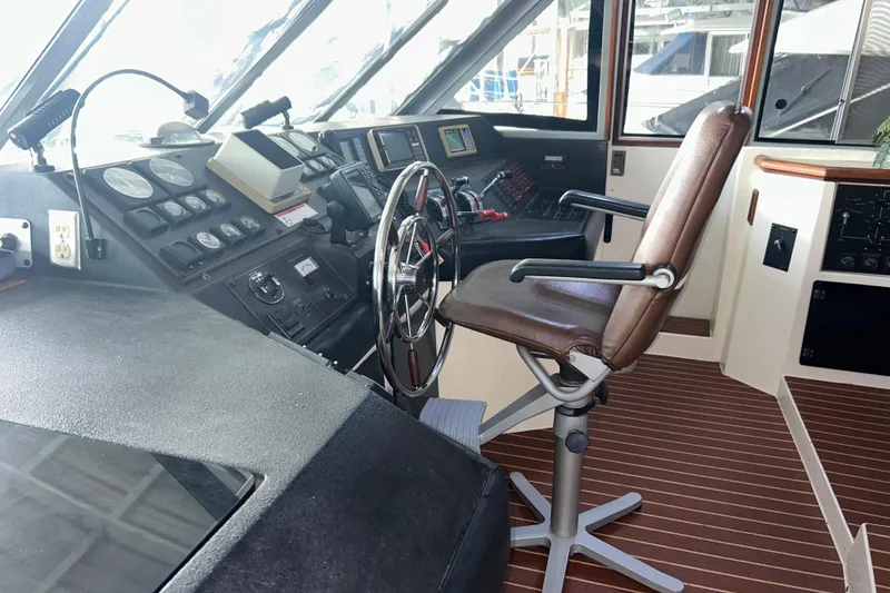 Slide: The Image of 1989 Bayliner 4588 Pilothouse interior with steering wheel and control panel. - 65