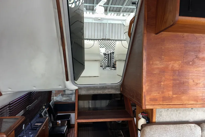 Slide: The Image of Interior view of 1989 Bayliner 4588 Pilothouse with wooden finishes and seating area. - 68