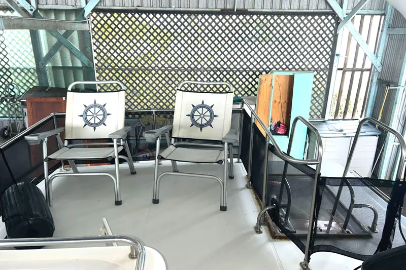 Slide: The Image of 1989 Bayliner 4588 Flybridge with nautical-themed chairs and railing. - 75