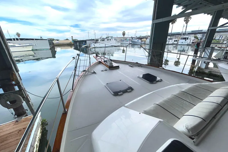 Slide: The Image of 1989 Bayliner 4588 Pilothouse yacht docked in a covered berth. - 79