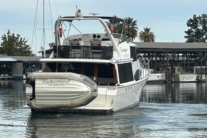Slide: The Image of 1989 Bayliner 4588 Pilothouse yacht docked in a marina, rear view. - 8