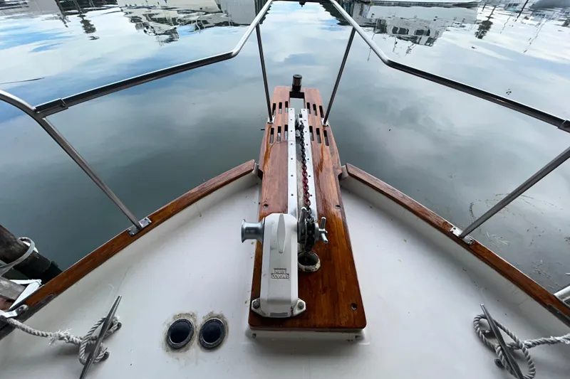 Slide: The Image of 1989 Bayliner 4588 Pilothouse bow with anchor chain and calm marina waters. - 80