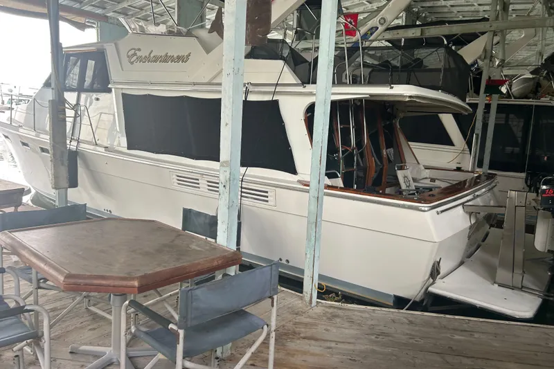 Slide: The Image of 1989 Bayliner 4588 Pilothouse yacht docked near outdoor seating area. - 83