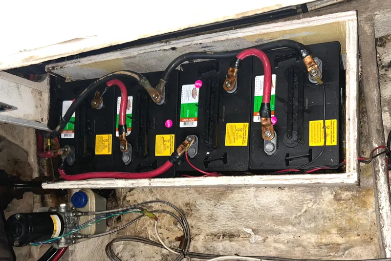 Slide: The Image of 1989 Bayliner 4588 Pilothouse battery compartment with multiple batteries and Sea Wise davit pump. - 89