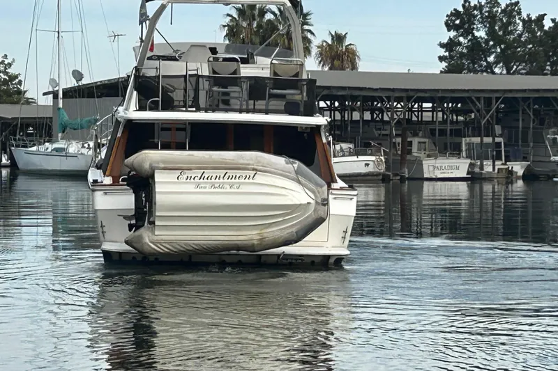 Slide: The Image of 1989 Bayliner 4588 Pilothouse yacht named "Enchantment" docked in a marina. - 9
