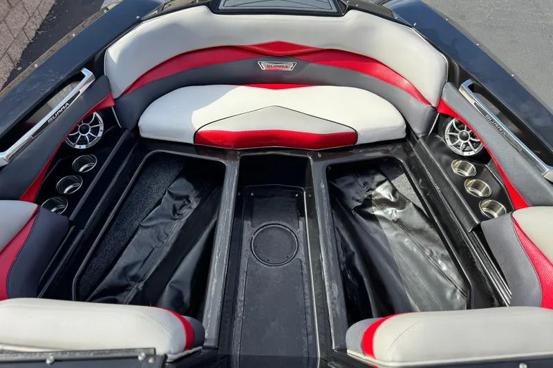 Slide: The Image of 2014 Supra SA350 boat interior with red and gray seating, cup holders, and speakers. - 12