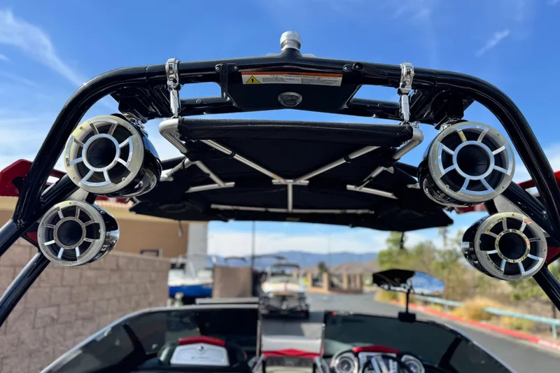 Slide: The Image of 2014 Supra SA350 boat with tower speakers and canopy under a clear blue sky. - 15