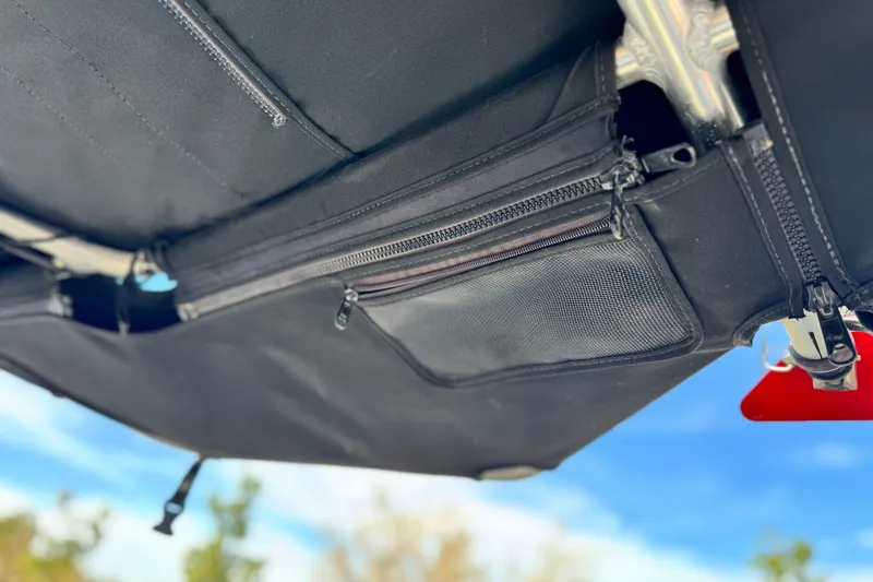 Slide: The Image of 2014 Supra SA350 boat canopy with zippered storage pockets, under a clear blue sky. - 17