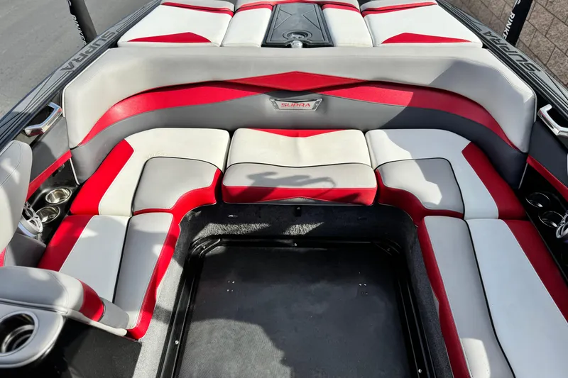 Slide: The Image of 2014 Supra SA350 boat interior with red and white cushioned seating. - 19