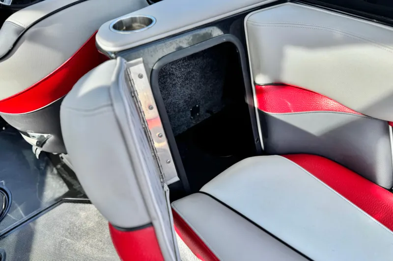 Slide: The Image of 2014 Supra SA350 boat interior with red and gray seating and cup holder. - 20