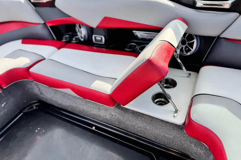 Slide: The Image of 2014 Supra SA350 boat interior with red and gray seating, cup holders, and speakers. - 21
