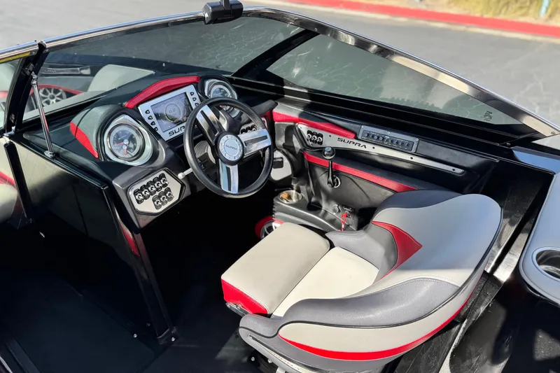 Slide: The Image of 2014 Supra SA350 boat interior with modern dashboard and steering wheel design. - 32