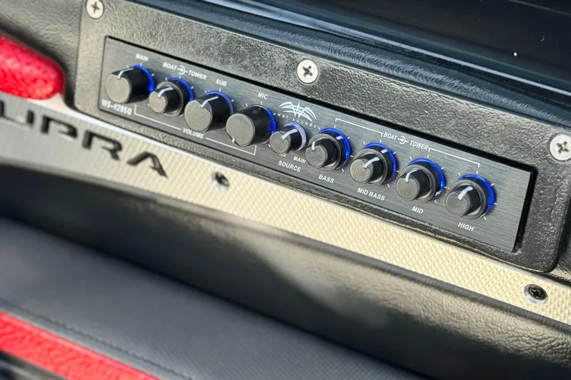 Slide: The Image of Audio control panel in a 2014 Supra SA350 boat with volume and bass knobs. - 42