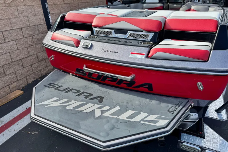 Slide: The Image of 2014 Supra SA350 boat with red and gray seating, featuring "Supra Worlds" branding. - 6