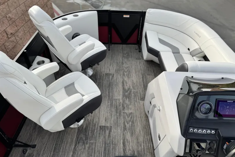 Slide: The Image of 2023 Viaggio Diamante 23E boat interior with white seating and modern dashboard. - 11