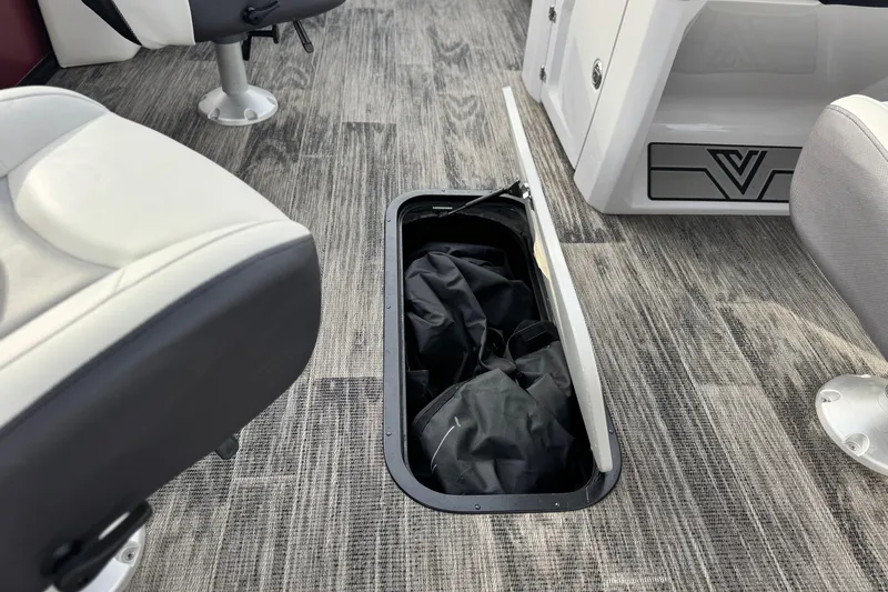 Slide: The Image of 2023 Viaggio Diamante 23E boat interior with open storage compartment on textured flooring. - 21