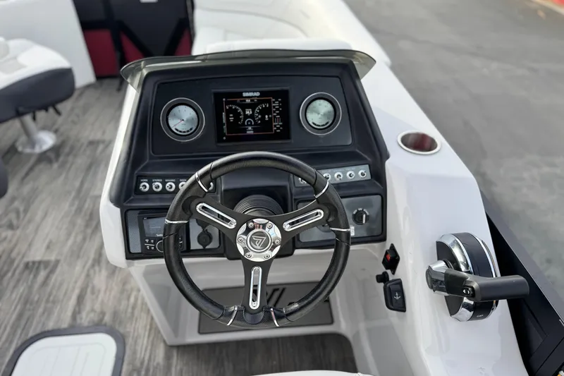 Slide: The Image of 2023 Viaggio Diamante 23E boat dashboard with steering wheel and control panel. - 23