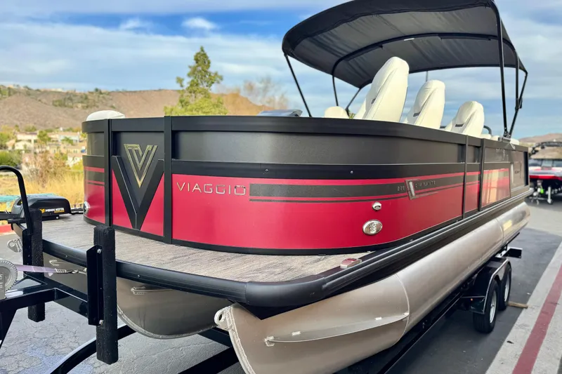Slide: The Image of 2023 Viaggio Diamante 23E pontoon boat with sleek red and black design on trailer. - 3