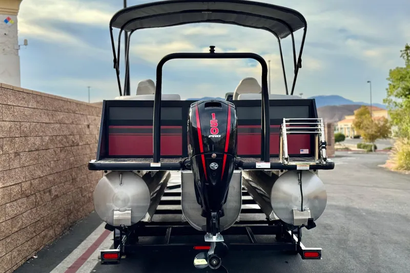 Slide: The Image of 2023 Viaggio Diamante 23E pontoon boat with 150 HP engine, parked outdoors. - 5