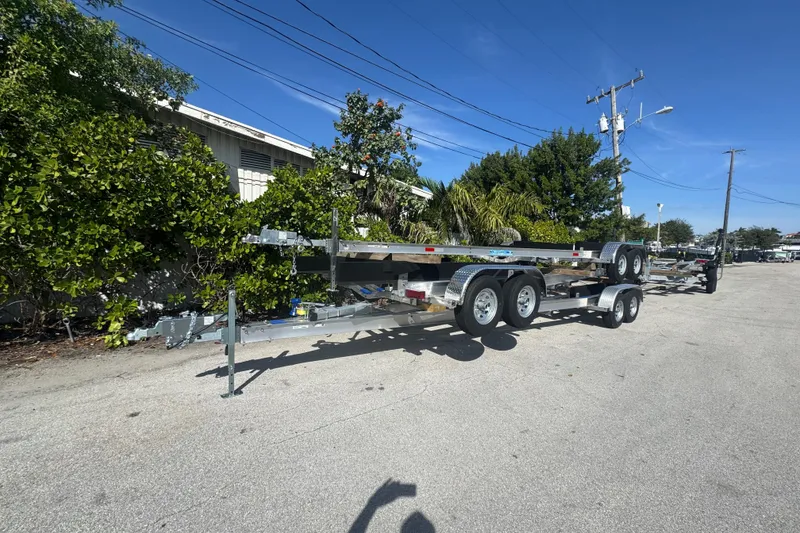 Slide: The Image of 2025 Trailers Trailer Mania parked on a sunny street, surrounded by greenery. - 3