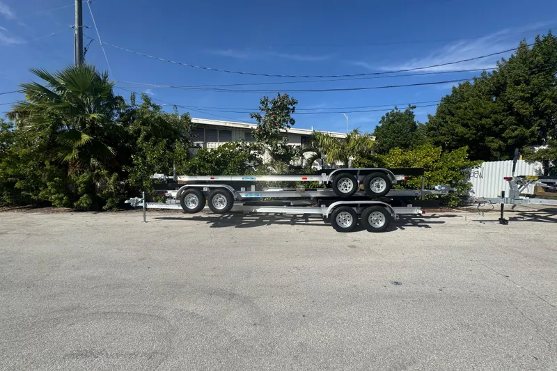 Slide: The Image of 2025 custom-built trailer with dual axles parked near lush greenery. - 5