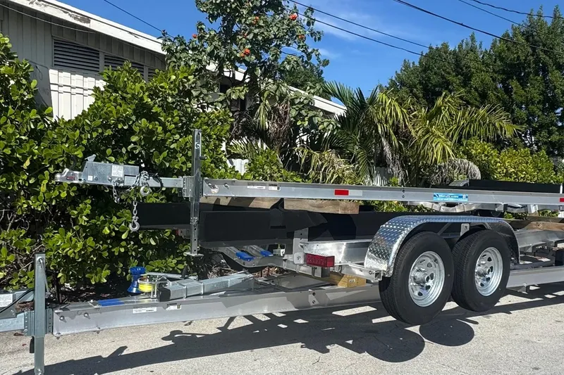 Slide: The Image of Custom-built 2025 trailer with dual wheels, parked outdoors near greenery. - 6