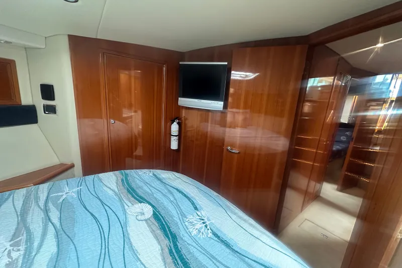 Slide: The Image of Interior of 2007 Riviera Sport Fisherman with wood paneling and mounted TV. - 11