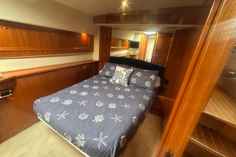 Slide: The Image of Luxurious cabin interior of 2007 Riviera Sport Fisherman yacht with elegant wood finish. - 13