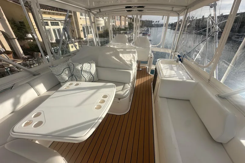 Slide: The Image of 2007 Riviera Sport Fisherman yacht interior with white seating and wooden flooring. - 27