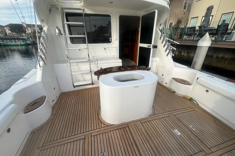Slide: The Image of 2007 Riviera Sport Fisherman boat deck with seating, fishing rod holders, and water view. - 43