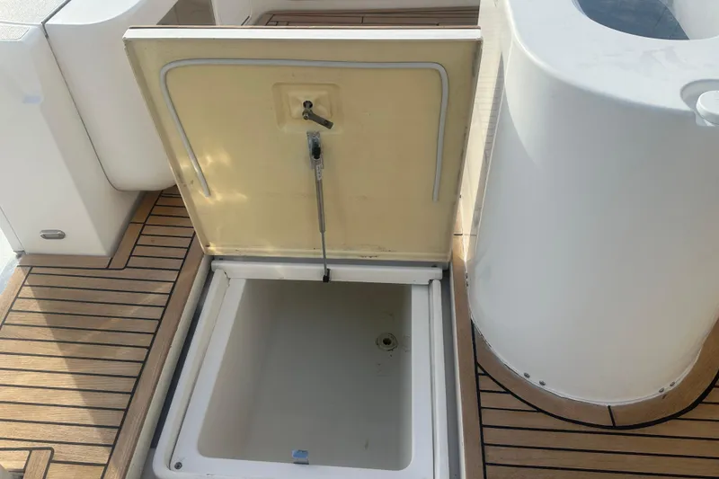 Slide: The Image of 2007 Riviera Sport Fisherman boat deck with wooden flooring and storage compartments. - 44