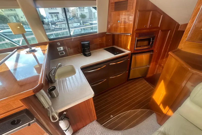 Slide: The Image of Luxurious 2007 Riviera Sport Fisherman yacht kitchen with modern appliances and elegant wood finish. - 5