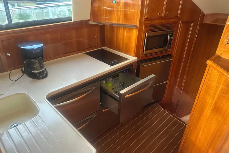 Slide: The Image of Luxurious 2007 Riviera Sport Fisherman yacht kitchen with modern appliances and wood finish. - 6