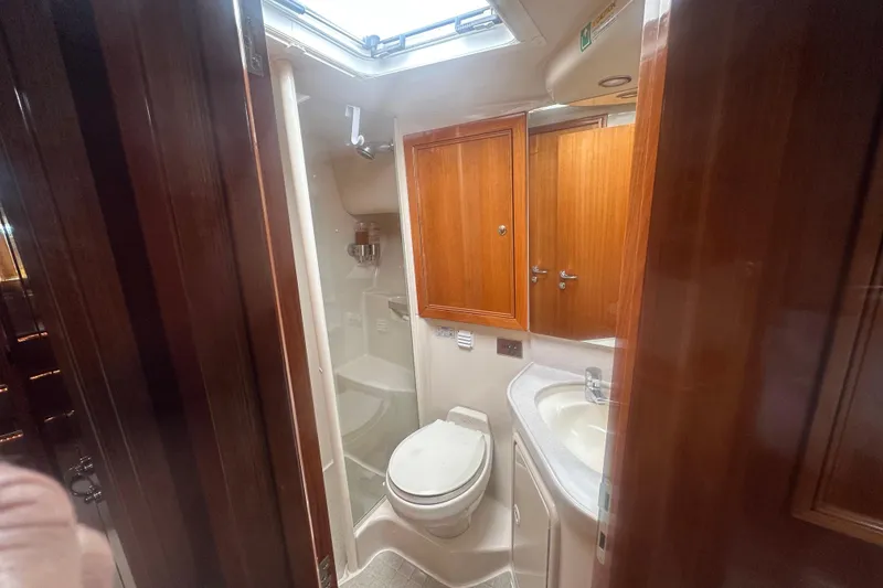 Slide: The Image of 2007 Riviera Sport Fisherman yacht bathroom with wooden cabinets and skylight. - 16