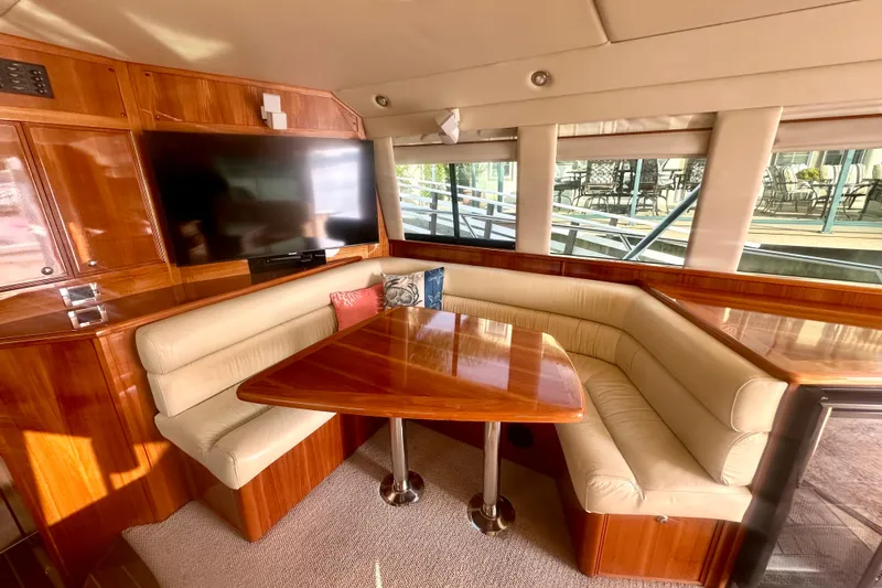 Slide: The Image of Luxurious 2007 Riviera Sport Fisherman yacht interior with plush seating and wooden table. - 2