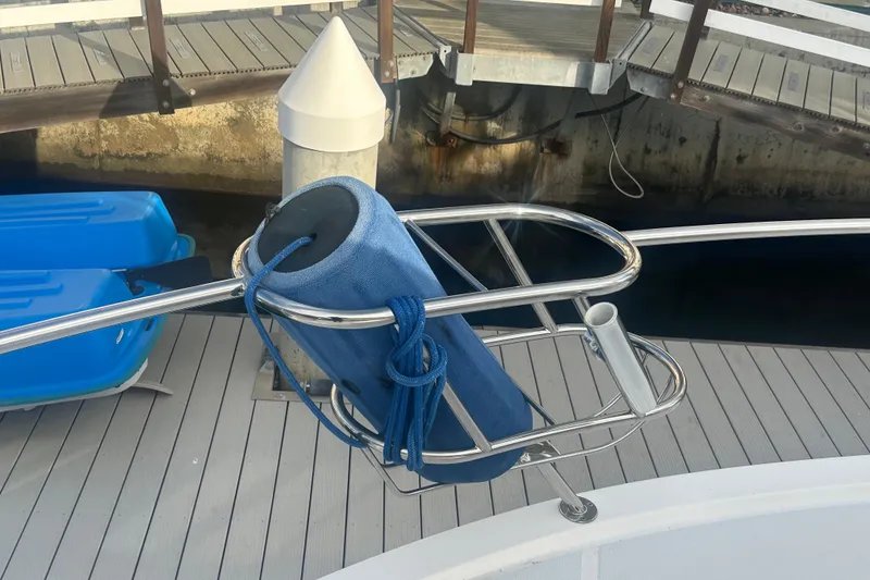 Slide: The Image of Riviera Sport Fisherman 2007 boat with blue fender and stainless steel railing. - 33