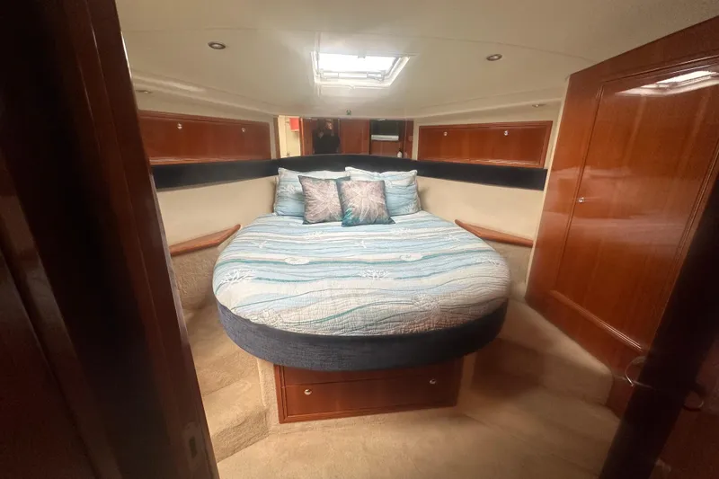 Slide: The Image of Luxurious cabin interior of a 2007 Riviera Sport Fisherman yacht with cozy bedding. - 10