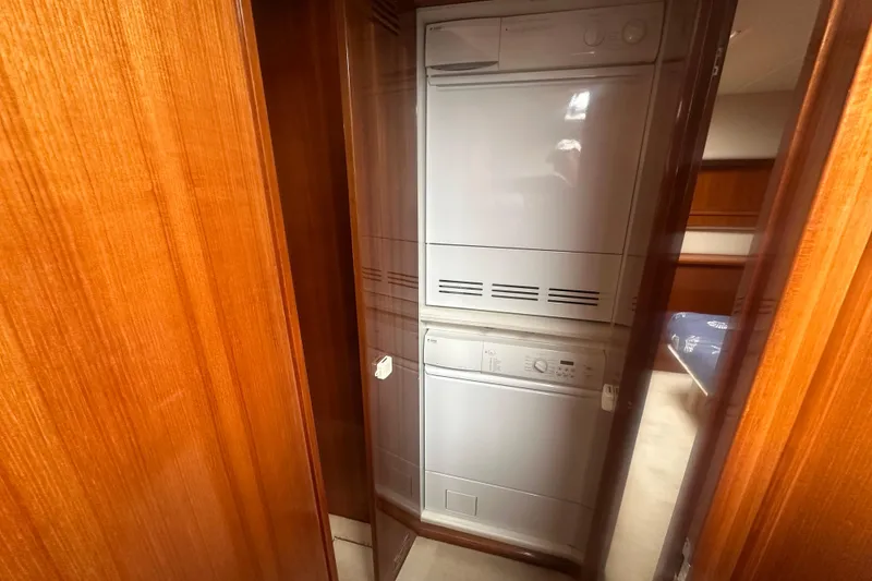 Slide: The Image of Laundry area inside 2007 Riviera Sport Fisherman yacht with wood paneling. - 19