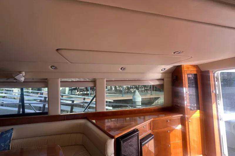 Slide: The Image of Interior of 2007 Riviera Sport Fisherman yacht with wooden cabinetry and seating area. - 24