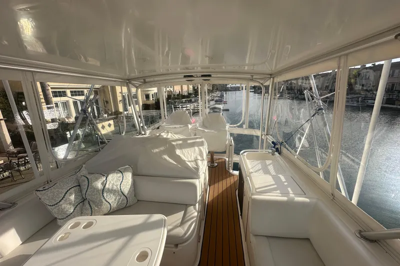 Slide: The Image of Luxurious 2007 Riviera Sport Fisherman yacht interior with plush seating and scenic marina view. - 28